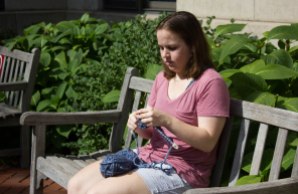 Anna Gregoire, 19, knits outside of Kilachand Hall in Boston, Mass., Tuesday, September 26, 2017.